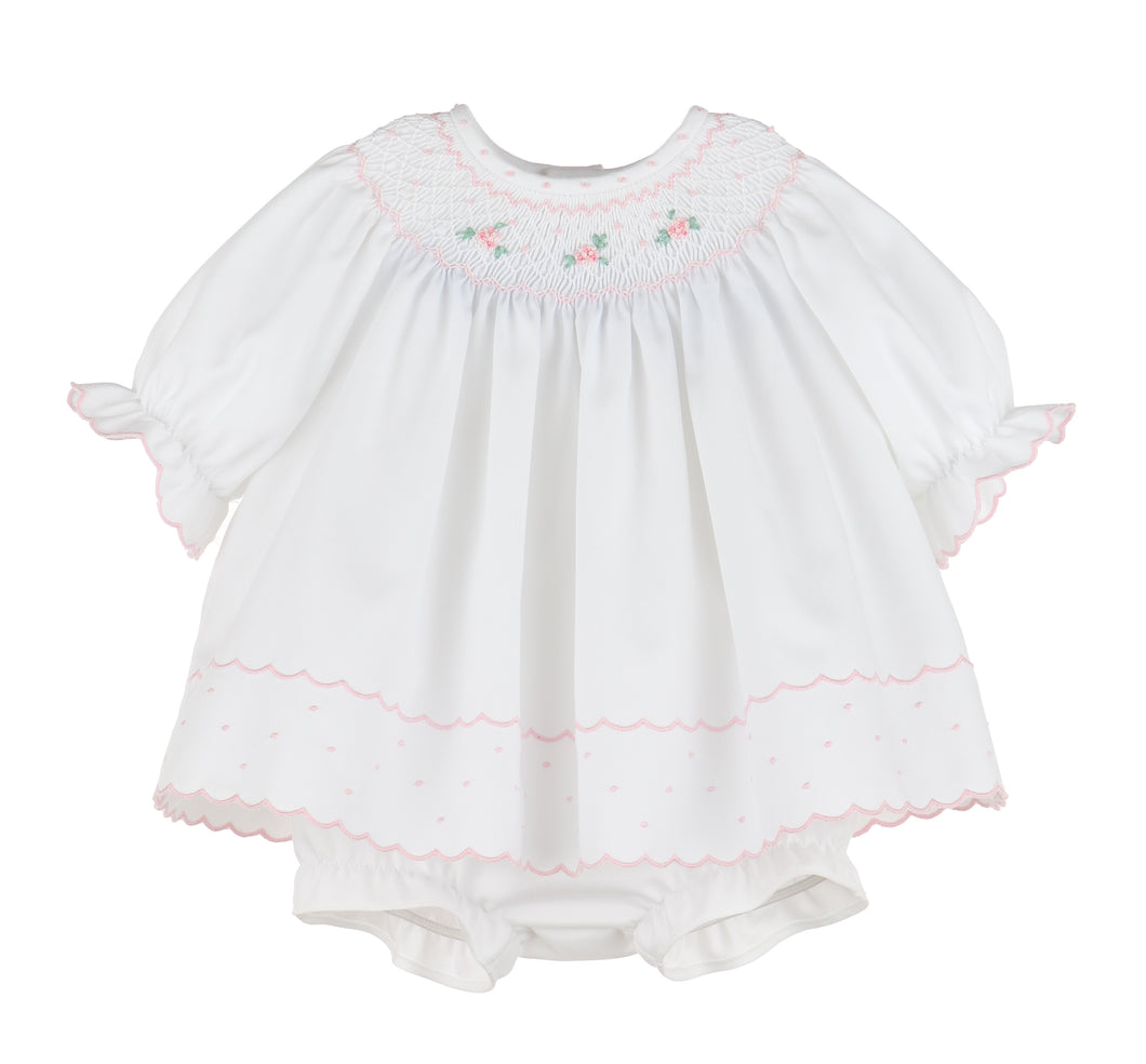 Dress your little one in timeless charm with the Infant Girl's Classic Embroidery Bishop Dress from Luli & Me. This beautiful white bishop dress features delicate hand-smocking and embroidery on the neckline, adding a touch of classic elegance in pink. Complete with a matching bloomers, it ensures both style and comfort for your infant. Perfect for special occasions or festive moments, this dress makes your baby shine with joyful brightness.