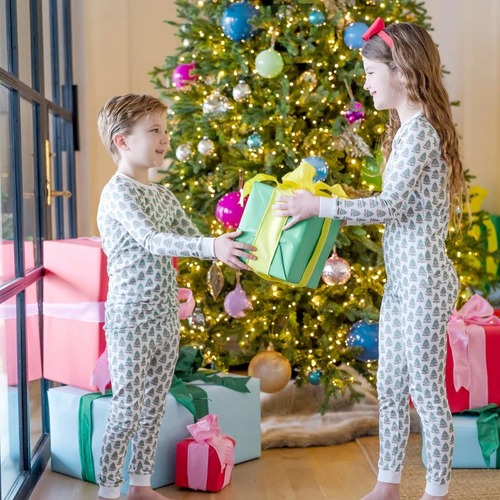 Celebrate cozy holiday moments with the Grayson Pajama Pant Set - Under the Christmas Tree by Lila & Hayes. This two-piece lounge set features a charming Christmas tree print on a soft, long-sleeved top and matching pants. Crafted from 100% Peruvian Pima cotton, it ensures exceptional comfort and breathability. Thoughtfully designed for durability and comfort, these pajamas make an ideal gift to keep your little ones warm and festive all season long. Unisex style.