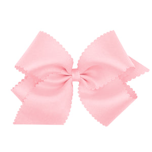 Elevate any outfit with this darling Light Pink Scalloped Bow from Wee Ones. Made from high-quality grosgrain material, this classic bow will add a touch of sweet charm to any look. Available in multiple sizes, it's the perfect accessory to complete your little one's wardrobe. Order now and add a pop of pink to her style!