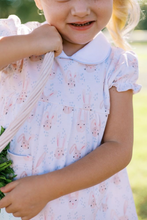 Load image into Gallery viewer, The Hoppy Bloomer Set, made with 100% Pima cotton for ultimate softness and comfort. The charming bunny print and Peter Pan collar add adorable touches, while the front pockets and coordinating blue bloomers offer practicality. Perfect for your little girl to celebrate the upcoming Easter season in comfort and style! Sibling match available in Jon Jon and Dress!
