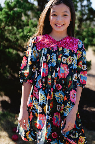 Elevate her style with the Briton Court Alice Dress. The unique sequin front detail and bold pattern will make her stand out with confidence. Perfect for any occasion, this dress is a must-have for your little fashionista.