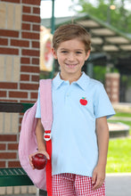 Load image into Gallery viewer, This classic light blue polo elevates your boy&#39;s back-to-school wardrobe with its charming apple applique logo. Perfect for classroom style or special occasions, this versatile shirt combines timeless design with playful details. Give your little one the confidence of looking polished while celebrating the school season in adorable fashion
