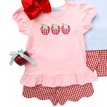 Load image into Gallery viewer, Delight your little one with this charming Toddler Girls Apple Trio Ruffle Short Set from Trotter Street. The pink ruffle hem tee showcases an adorable apple trio applique that celebrates the back-to-school season with style. Paired with eye-catching red and white checked shorts featuring a sweet scallop hem, this coordinated outfit offers both comfort and irresistible charm. Perfect for making a memorable impression on the first day of school or any summer playdate!
