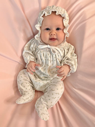 Dress your little one in the Bella Pink Floral Hand Smocked Bishop Footie by Baby Loren, crafted from soft pima cotton for gentle comfort. Its delicate bishop smocked neckline and elegant floral embroidery add timeless charm, making it perfect for special occasions or everyday wear. This beautifully detailed footie ensures your infant girl stays cozy while looking effortlessly adorable.