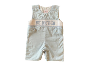 Celebrate his special role with the Boys Big Brother Smocked Jon Jon from Shop Teeta. Featuring a charming blue and white gingham print Jon Jon with smocked detail with embroidered with "BIG BROTHER". This jon jon offers a timeless, sweet look perfect for brother promotions and baby arrival announcements. Comfortable and stylish, it highlights his new status with grace, making every moment unforgettable.