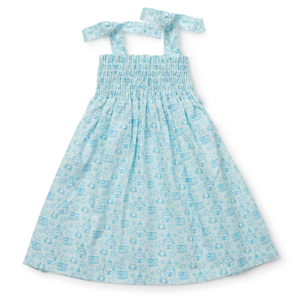 Get ready for some fun in the sun with the Sandcastles Blue Betsy Dress from Lila & Hayes! This toddler dress features a vibrant ocean blue color with a playful sand castle design and comfortable smocked bodice. The tie straps add an extra touch of cuteness. Available in sizes 2t-6, this dress is perfect for a beach vacation.