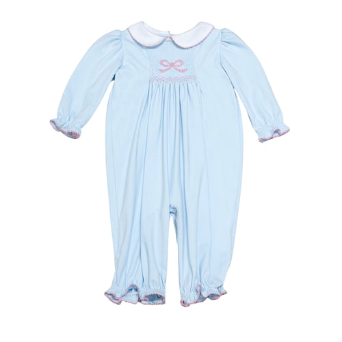 This Infant Girls Sylvie Bow Bubble in soft light blue combines charming details with comfort. Featuring delicate smocking and a hand-embroidered bow on the front, it adds a touch of elegance to your little one’s wardrobe. The classic Peter Pan collar and gentle ruffle hems complete this timeless look, perfect for special occasions or everyday wear. Crafted for softness and ease, it ensures your baby stays cozy while looking irresistibly sweet.
