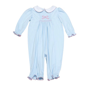 This Infant Girls Sylvie Bow Bubble in soft light blue combines charming details with comfort. Featuring delicate smocking and a hand-embroidered bow on the front, it adds a touch of elegance to your little one’s wardrobe. The classic Peter Pan collar and gentle ruffle hems complete this timeless look, perfect for special occasions or everyday wear. Crafted for softness and ease, it ensures your baby stays cozy while looking irresistibly sweet.