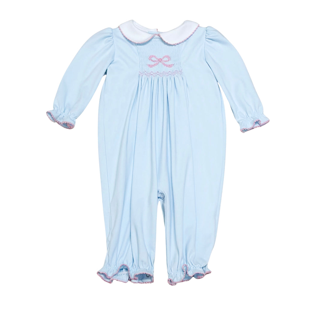 This Infant Girls Sylvie Bow Bubble in soft light blue combines charming details with comfort. Featuring delicate smocking and a hand-embroidered bow on the front, it adds a touch of elegance to your little one’s wardrobe. The classic Peter Pan collar and gentle ruffle hems complete this timeless look, perfect for special occasions or everyday wear. Crafted for softness and ease, it ensures your baby stays cozy while looking irresistibly sweet.