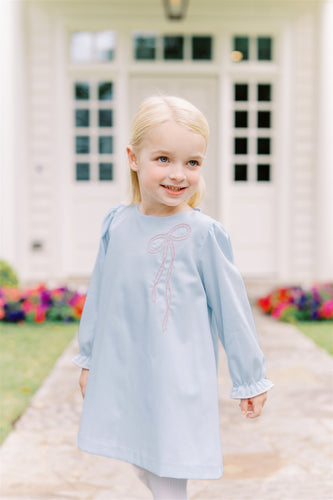 The Brooklyn Bow Dress from The Proper Peony offers timeless elegance with its classic A-line silhouette and delicate embroidered bow detail. Perfectly blending style and simplicity, this dress captures the charming bow trend for little girls, making it an ideal choice for special occasions or everyday wear. Its refined design ensures your child looks effortlessly stylish and comfortable all day long.