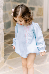 The Brooklyn Bow Bubble from The Proper Peony offers timeless elegance with its classic silhouette and delicate embroidered bow detail. Perfectly blending style and simplicity, this bubble captures the charming bow trend for little girls, making it an ideal choice for special occasions or everyday wear. Its refined design ensures your child looks effortlessly stylish and comfortable all day long.