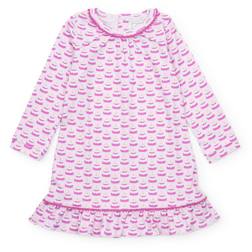 Celebrate in style with the Carlin Girls' Lounge Dress in Birthday Cake Pink by Lila & Hayes. This charming dress features a playful birthday-themed print, making it the perfect pajama dress for any special celebration. Pair it with the matching doll dress & boy’s shorts set for coordinated birthday moments that everyone will love.