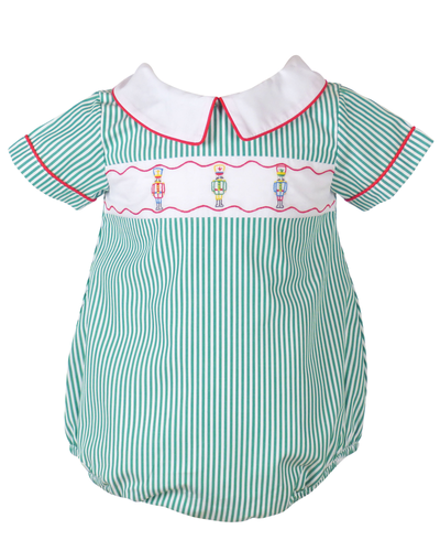 Dress your little one in festive charm with the Infant Boys Bellamy Nutcracker Bubble from The Yellow Lamb. This adorable outfit features a classic green and white stripe pattern accented by detailed nutcracker embroidery on the front. Ideal for Santa visits or family photos, it combines comfort and holiday spirit effortlessly, making your baby the star of any seasonal occasion.