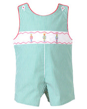 Load image into Gallery viewer, Dress your little one in festive charm with the Boys Jean Nutcracker Jon Jon from The Yellow Lamb. This adorable outfit features a classic green and white stripe pattern accented by detailed nutcracker embroidery on the front. Ideal for Santa visits or family photos, it combines comfort and holiday spirit effortlessly, making your baby the star of any seasonal occasion.
