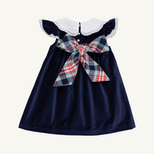 Load image into Gallery viewer, The Beaufort Bonnet Company’s beloved Franny Frock in charming Nantucket Navy with Worth Avenue White and Covington Cottage Plaid is a must-have for every little girl's wardrobe. This adorable girls' dress features a sweet plaid patterned bow that's perfect for tea parties, portraits, and special occasions. It's a timeless piece that brings Southern charm to every wardrobe!

