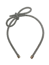 Load image into Gallery viewer, Introducing the Glitter Bow Slim Headband from Anuja Tolia Jewelry! This bedazzled headband features a stunning accent bow and comes in 3 different colors. Perfect for any young fashionista looking to add a touch of sparkle and style to their outfit!
