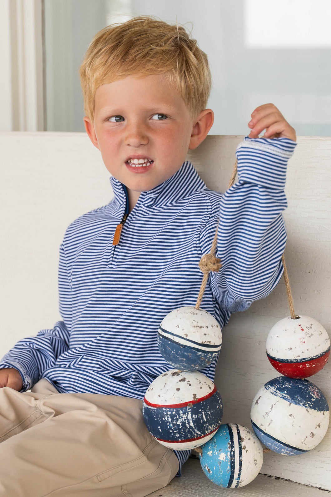 The Boys Blue Stripe Collins Quarter Zip offers a soft-knit feel in a classic navy stripe design, perfect for toddlers to tweens. This long sleeve pullover combines comfort and style, making it ideal for layering on cooler days or wearing alone for a casual, polished look. Durable and versatile, it’s a smart addition to any young boy’s wardrobe.