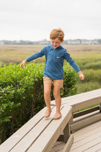 Keep your little adventurer cool and protected with the Boy's Tuna Performance Hoodie from Saltwater Boys. Crafted from breathable, performance fabric with UPF 50+ protection, this blue hoodie shields young skin from harmful sun rays during outdoor play. The striking tuna fish graphic on the back adds a splash of style, while the classic SWB logo on the front offers a timeless look. Perfect for toddlers to tweens, this hoodie combines comfort, sun safety, and standout design in one versatile piece.