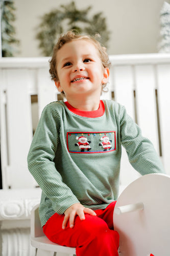 This charming green and white mini striped long sleeve tee features a smocked front adorned with delicate hand-embroidered Santas, adding a unique festive touch. Perfectly paired with the coordinating red cords, it creates a stylish holiday outfit your little one will love. Sibling matching options make family photos even more memorable. Celebrate the season with comfort and timeless style in this playful Santa Claus tee.