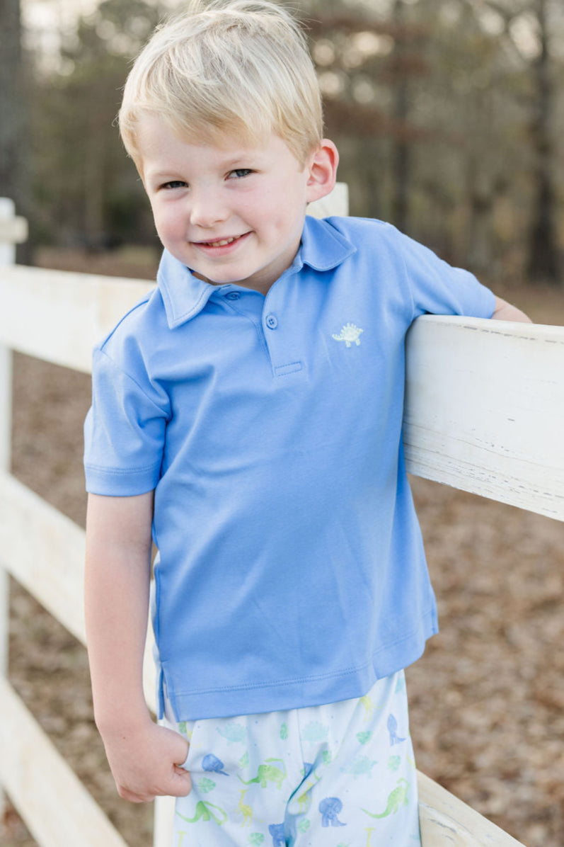 Elevate your style with our Blue Polo featuring a bold Dino Embroidery. The royal blue color and coordinating dinosaur emblem add a playful touch. Perfect for any occasion, pair it with our Dinosaur Conrad Shorts for a complete look.