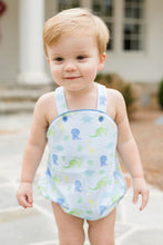 Load image into Gallery viewer, Experience endless adventures with the Louie Dinosaur Knit Bubble from James &amp; Lottie! This charming bubble features a soft blue background and vibrant dinosaur print, perfect for your little one&#39;s summer wardrobe. The crisscross strap adds an extra touch of charm to this must-have piece.
