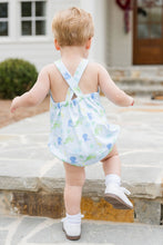 Load image into Gallery viewer, Experience endless adventures with the Louie Dinosaur Knit Bubble from James &amp; Lottie! This charming bubble features a soft blue background and vibrant dinosaur print, perfect for your little one&#39;s summer wardrobe. The crisscross strap adds an extra touch of charm to this must-have piece.
