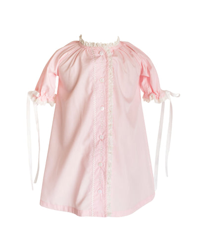 The Katherine Daygown in Pink is a timeless coming home outfit for newborn girls, featuring a classic button-up front and embroidery, offering an elegant silhouette. Its delicate details of lace and embroidery along the edges adds a heartfelt touch, making it a cherished heirloom piece to treasure for years. Perfect for welcoming your little one in style and sentiment.