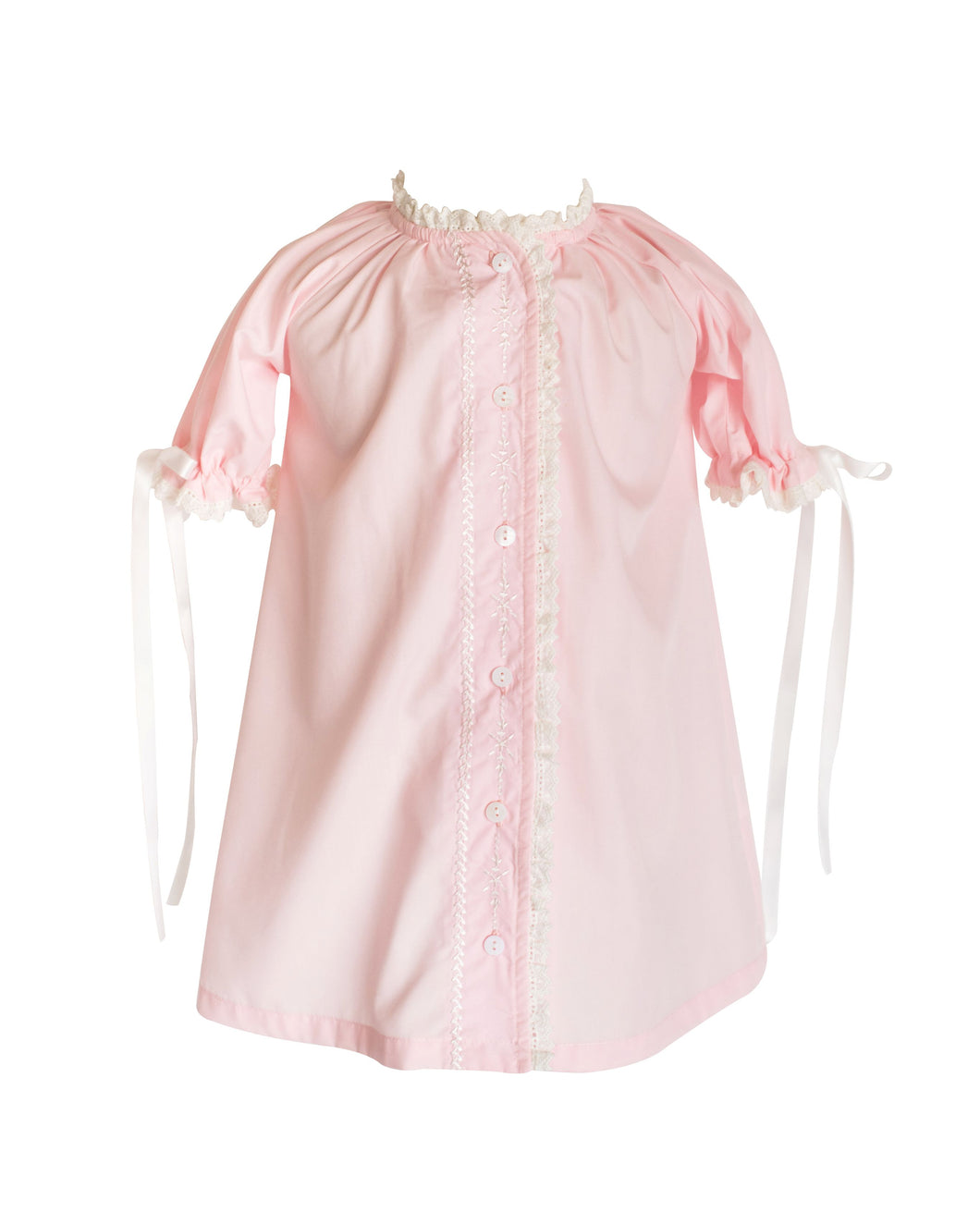 The Katherine Daygown in Pink is a timeless coming home outfit for newborn girls, featuring a classic button-up front and embroidery, offering an elegant silhouette. Its delicate details of lace and embroidery along the edges adds a heartfelt touch, making it a cherished heirloom piece to treasure for years. Perfect for welcoming your little one in style and sentiment.