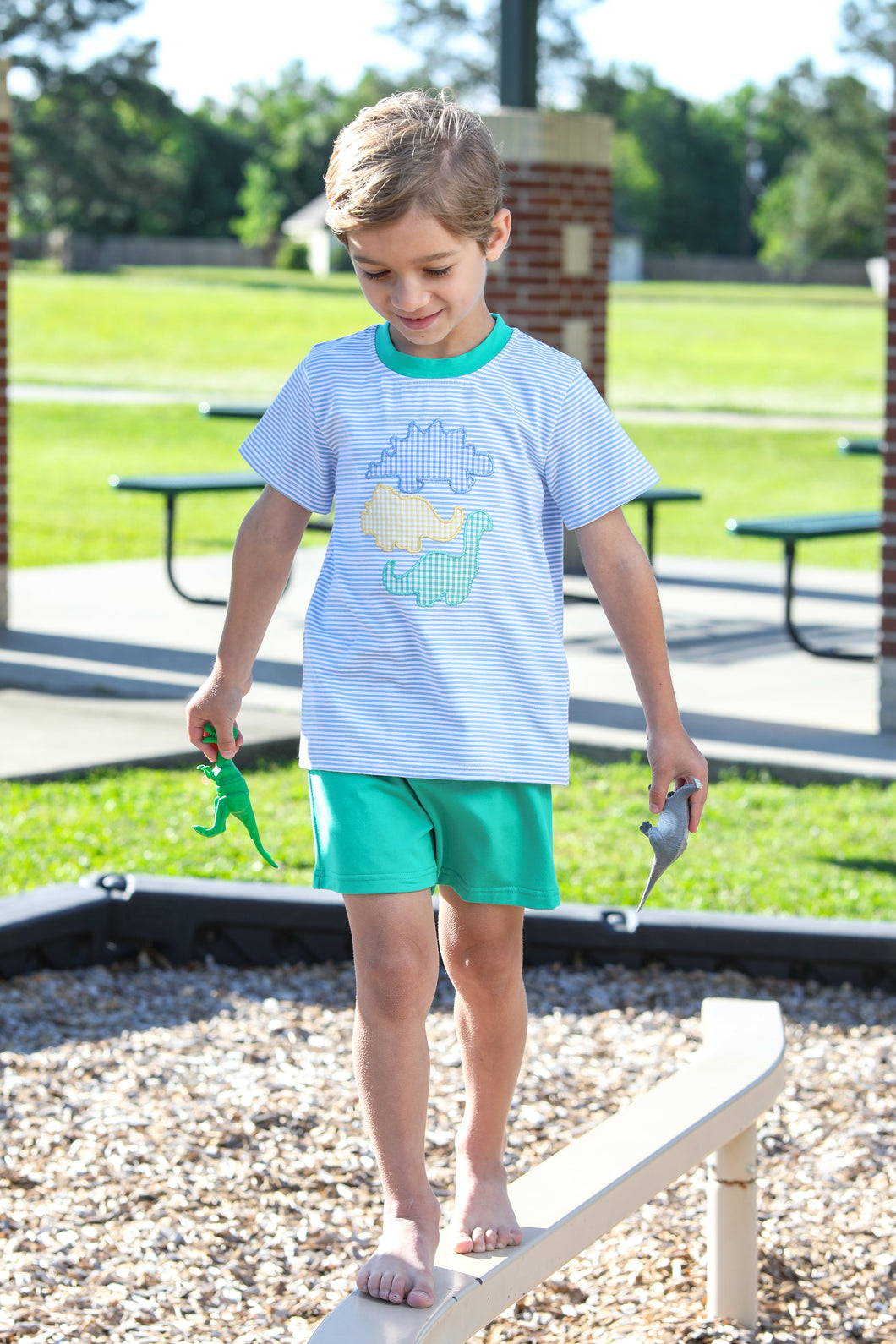 Introduce your little one to the adorable world of dinosaurs with our Toddler Boys Striped Dinosaur Shorts Set! Made from soft knit fabric, this set features charming dinosaur appliques that will surely capture your child's imagination. Perfect for playtime, parties, or everyday wear. Give your child a fun and comfortable outfit with this set from Trotter Street Kids.