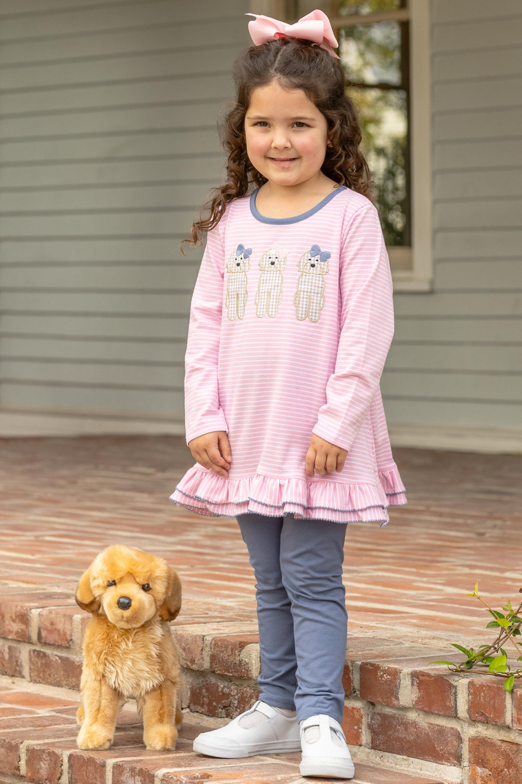 Dress your little girl in playful style with the Girls Dog Ruffle Legging Set from Trotter Street Kids. This charming outfit features a pink striped long sleeve tunic adorned with adorable embroidered dog appliques that add a fun, whimsical touch. Coordinating leggings provide comfort and flexibility for all-day play. 