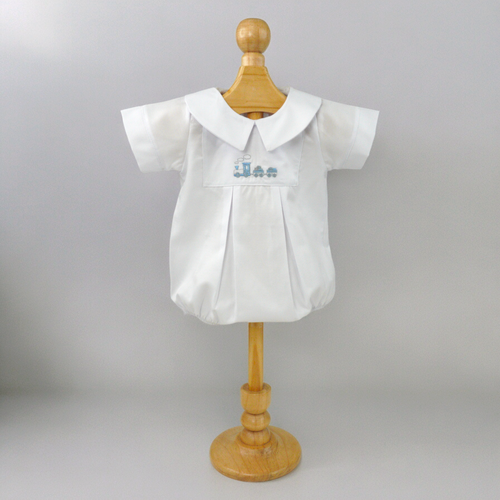 Introduce your little one to timeless style with our Embroidered Pique Train Bubble. Made from classic pique material, this white bubble features an adorable embroidered train design. From playdates to special occasions, your baby will look effortlessly stylish in this bubble by Marcela.