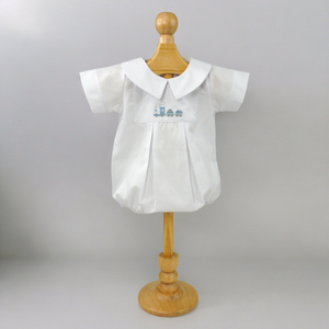 Introduce your little one to timeless style with our Embroidered Pique Train Bubble. Made from classic pique material, this white bubble features an adorable embroidered train design. From playdates to special occasions, your baby will look effortlessly stylish in this bubble by Marcela.