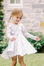 Load image into Gallery viewer, The Girls En Pointe Twirl Dress from The Proper Peony features a soft knit fabric adorned with an elegant ballet and bow print. Its charming ruffle detail and flowy design invite endless twirling, making it perfect for a day filled with dance and delight. Comfortable and stylish, this dress is sure to inspire her graceful moves and joyful moments.
