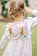Load image into Gallery viewer, The Girls En Pointe Twirl Dress from The Proper Peony features a soft knit fabric adorned with an elegant ballet and bow print. Its charming ruffle detail and flowy design invite endless twirling, making it perfect for a day filled with dance and delight. Comfortable and stylish, this dress is sure to inspire her graceful moves and joyful moments.
