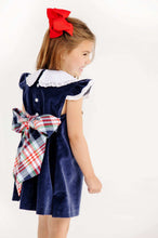Load image into Gallery viewer, The Beaufort Bonnet Company’s beloved Franny Frock in charming Nantucket Navy with Worth Avenue White and Covington Cottage Plaid is a must-have for every little girl's wardrobe. This adorable girls' dress features a sweet plaid patterned bow that's perfect for tea parties, portraits, and special occasions. It's a timeless piece that brings Southern charm to every wardrobe!
