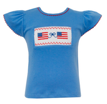 Load image into Gallery viewer, The Girl's Smocked Flags Short Set by Anavini is the perfect summer outfit for your little one. The blue knit tee with red trim and charming flag smocking adds a touch of patriotic flair, while the periwinkle blue gingham shorts provide comfort and style. It's a must-have for any fashionable and patriotic girl!
