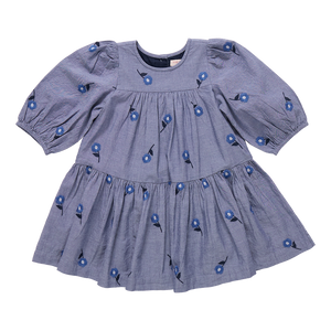 The Girls Fiona Dress in Blue Blossom Embroidery features vibrant embroidered blossom patterns that make your girl truly stand out. Designed with comfort and style in mind, this dress allows for easy movement while adding a magical touch to any occasion. Perfect for celebrations or everyday adventures, it brings a charming blend of elegance and playful style to her wardrobe.
