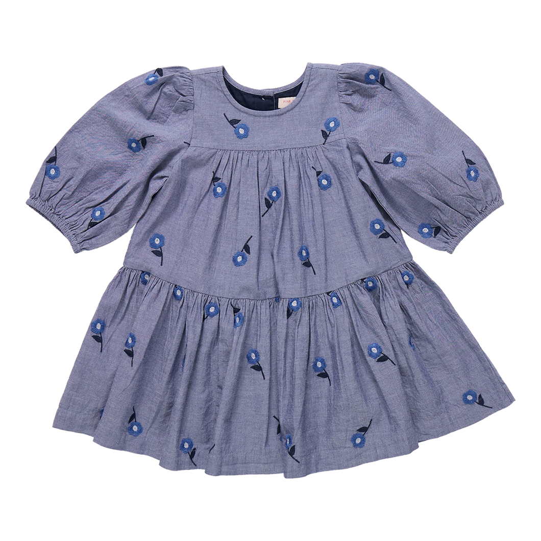 The Girls Fiona Dress in Blue Blossom Embroidery features vibrant embroidered blossom patterns that make your girl truly stand out. Designed with comfort and style in mind, this dress allows for easy movement while adding a magical touch to any occasion. Perfect for celebrations or everyday adventures, it brings a charming blend of elegance and playful style to her wardrobe.