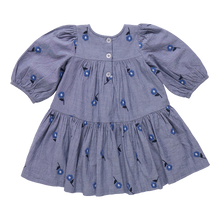 Load image into Gallery viewer, The Girls Fiona Dress in Blue Blossom Embroidery features vibrant embroidered blossom patterns that make your girl truly stand out. Designed with comfort and style in mind, this dress allows for easy movement while adding a magical touch to any occasion. Perfect for celebrations or everyday adventures, it brings a charming blend of elegance and playful style to her wardrobe.
