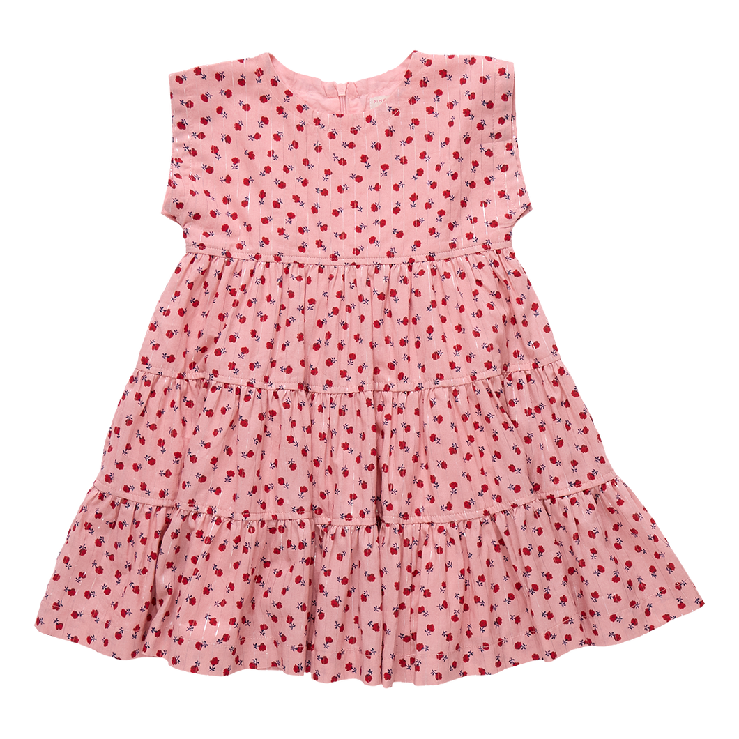 The Girls Peachy Dress in Pink Tiny Roses is a charming choice for fall occasions. Adorned with delicate pink roses and featuring a tiered skirt, this dress combines timeless style with playful elegance. Perfect for making your little girl stand out at any event, it offers both comfort and classic beauty.