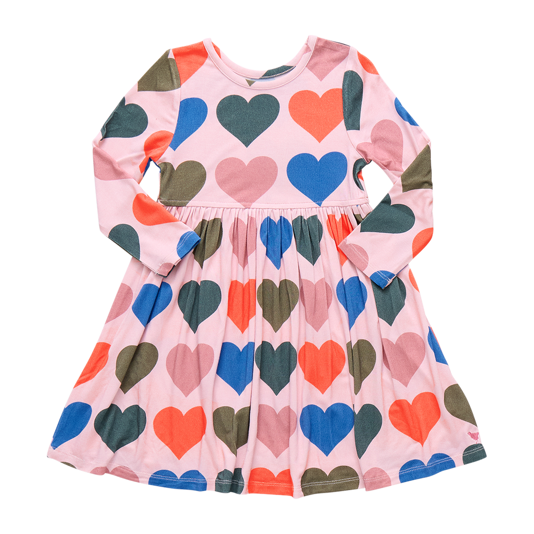 Dress your little one in the Girls Steph Bamboo Dress by Pink Chicken, featuring a charming oversized hearts pattern. Made from soft, breathable bamboo fabric, this long-sleeve, knee-length dress ensures all-day comfort while adding a playful splash of color to her wardrobe. Perfect for any occasion, it combines style and coziness effortlessly.