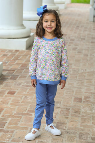 The Girls Floral Reagan Pant Set from Trotter Street combines a lively floral print top with charming periwinkle leggings featuring a delicate scalloped hem. This coordinated outfit offers both style and comfort, perfect for adding a fresh, playful touch to your little girl's wardrobe. Ideal for everyday wear or special occasions, it ensures she looks effortlessly adorable while staying comfortable all day.