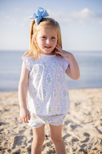 The Proper Peony's Blossom Bow Bloomer Set is a must-have for any infant girl! Made with 100% pima cotton, this set features a charming Forget Me Not flower print, sleeveless flutter sleeves, and a comfortable bloomer. Perfect for keeping your little one cool and stylish during the warmer months!