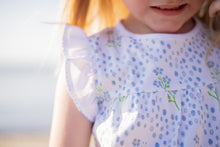 Load image into Gallery viewer, The Proper Peony&#39;s Blossom Bow Bloomer Set is a must-have for any infant girl! Made with 100% pima cotton, this set features a charming Forget Me Not flower print, sleeveless flutter sleeves, and a comfortable bloomer. Perfect for keeping your little one cool and stylish during the warmer months!
