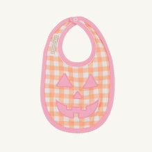 Load image into Gallery viewer, The Beaufort Bonnet Company’s Burp Me Bib in Seashore Sherbet Gingham &amp; Hamptons Hot Pink is the sweetest fall baby essential, with a Jack-O-Lantern face on the front, picot and trim along the outer edge, and a snap closure. Pretty and practical meet in the most festive way!
