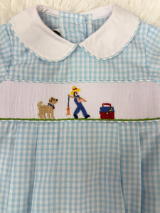 This Infant Boys Gone Fishing Bubble showcases a charming blue and white gingham pattern, highlighted by a detailed smocked fisherman &amp; his best friend embroidery on the front. Designed for comfort and style, creating an adorable and polished outfit ideal for playful days and special occasions.