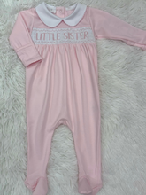 Load image into Gallery viewer, Introduce your little one to timeless elegance with this charming Little Sister Smocked Footie from Magnolia Baby. Crafted with meticulous attention to detail, the delicate smocking adds a touch of sophistication to everyday wear. The soft, breathable fabric keeps your baby comfortable throughout the day and night, while the convenient footie design means easy diaper changes and secure warmth. 
