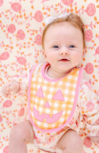 Load image into Gallery viewer, The Beaufort Bonnet Company’s Burp Me Bib in Seashore Sherbet Gingham &amp; Hamptons Hot Pink is the sweetest fall baby essential, with a Jack-O-Lantern face on the front, picot and trim along the outer edge, and a snap closure. Pretty and practical meet in the most festive way!

