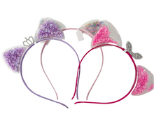 Load image into Gallery viewer, Add a whimsical touch to your little girl&#39;s accessories with Anuja Tolia&#39;s Embellished Ear Headbands! These playful headbands come in 3 colors and are sure to be a hit with your fashion-forward child.

