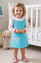 Load image into Gallery viewer, The Bow Hayden Jumper by Zuccini Kids wraps your little one in soft blue corduroy, beautifully accented with a delicate pink bow appliqué. Perfectly paired with a crisp white shirt, it brings timeless charm and comfort to every toddler’s day. White shirt not included. 
